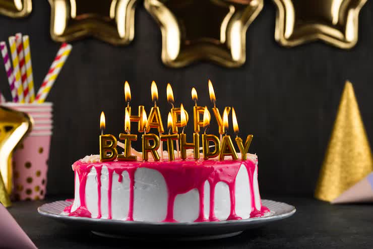 Celebration cake with glowing birthday candles